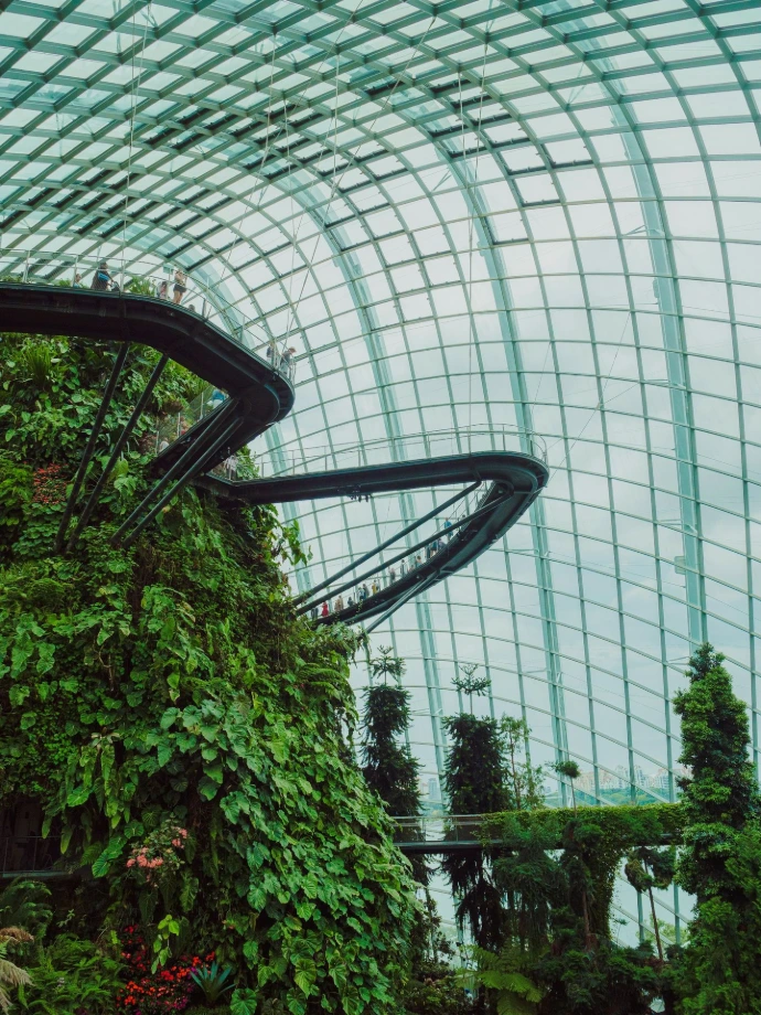 Lush greenery thrives in an expansive glass dome.